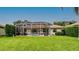 View of the screened pool area from the manicured backyard at 5897 Carriage Dr, Sarasota, FL 34243