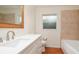 Bright bathroom featuring tiled floors and walls, a vanity with a sink, and a window for natural light at 5897 Carriage Dr, Sarasota, FL 34243