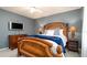 Bedroom with a wood bed frame, blue walls, and soft lighting at 5897 Carriage Dr, Sarasota, FL 34243