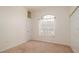 Bedroom with a neutral carpet, window and closet at 5897 Carriage Dr, Sarasota, FL 34243