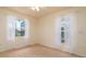Inviting bedroom with dual windows providing a scenic view of the pool and lake at 5897 Carriage Dr, Sarasota, FL 34243