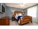 Cozy bedroom with a wood bed frame, blue walls, and soft lighting at 5897 Carriage Dr, Sarasota, FL 34243