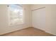 Bedroom with a neutral carpet, window and closet at 5897 Carriage Dr, Sarasota, FL 34243