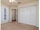 Bright, carpeted bedroom with ample closet space and access to the en-suite bathroom at 5897 Carriage Dr, Sarasota, FL 34243
