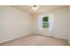 Cozy bedroom with natural light, neutral carpet, and a view of the outdoors at 5897 Carriage Dr, Sarasota, FL 34243