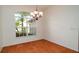 Bright dining room showcasing tile floors, a chandelier, and a large window overlooking greenery at 5897 Carriage Dr, Sarasota, FL 34243