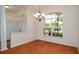 Bright dining room showcasing tile floors, a modern chandelier, and a large window overlooking greenery at 5897 Carriage Dr, Sarasota, FL 34243