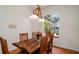 Dining room showcasing rustic wood table, floral centerpiece, and a view to the lanai at 5897 Carriage Dr, Sarasota, FL 34243