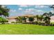 Charming single-Gathering home with a well-manicured lawn and tropical landscaping at 5897 Carriage Dr, Sarasota, FL 34243