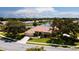 Beautiful home with tile roof, mature trees and landscaping on a well manicured lot bordering a small lake at 5897 Carriage Dr, Sarasota, FL 34243