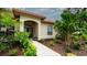 Charming front entrance with lush landscaping and a well-maintained walkway at 5897 Carriage Dr, Sarasota, FL 34243