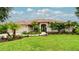 Beautiful front yard with lush green grass, palm trees, and a well-maintained garden leading to the charming home at 5897 Carriage Dr, Sarasota, FL 34243