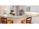 Bright kitchen featuring stainless appliances, white cabinets, and granite countertops at 5897 Carriage Dr, Sarasota, FL 34243