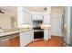 Bright kitchen featuring stainless appliances, white cabinets, and granite countertops at 5897 Carriage Dr, Sarasota, FL 34243