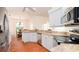 Bright kitchen featuring stainless appliances, white cabinets, and granite countertops at 5897 Carriage Dr, Sarasota, FL 34243