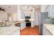 Bright kitchen featuring stainless appliances, white cabinets, and granite countertops at 5897 Carriage Dr, Sarasota, FL 34243
