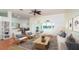 Bright living room showcasing tile floors, ceiling fan, and large windows looking out to a beautiful pool at 5897 Carriage Dr, Sarasota, FL 34243