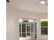 Bright living room featuring a ceiling fan and sliding doors to the outdoor lanai at 5897 Carriage Dr, Sarasota, FL 34243