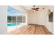 Open living area with hardwood flooring overlooking the screened-in pool at 5897 Carriage Dr, Sarasota, FL 34243