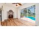 Bright open living room with views of the pool and screened-in lanai area at 5897 Carriage Dr, Sarasota, FL 34243