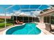 Backyard pool area with lounge chairs, privacy screen and greenery for relaxation and enjoyment at 5897 Carriage Dr, Sarasota, FL 34243