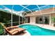 Sparkling pool area with lounge chairs, lush plants, and privacy screens at 5897 Carriage Dr, Sarasota, FL 34243