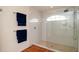 Modern walk-in shower with glass enclosure and a pebbled floor at 5897 Carriage Dr, Sarasota, FL 34243