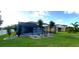 Backyard with a pool, landscaping, and view of neighboring houses at 6107 French Creek Ct, Ellenton, FL 34222