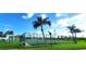 Community basketball court with palm trees and green grass at 6107 French Creek Ct, Ellenton, FL 34222