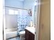 Bathroom featuring a bathtub, toilet, vanity with sink, and a flower-themed shower curtain at 6107 French Creek Ct, Ellenton, FL 34222