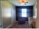 Bedroom with a crib, chair, a large window, closet, and an antique table at 6107 French Creek Ct, Ellenton, FL 34222
