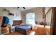 Bedroom with hardwood floors, featuring a bed, dresser, and ample natural light at 6107 French Creek Ct, Ellenton, FL 34222