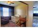 Bedroom with a white crib, plush chair, an antique table, and a large window at 6107 French Creek Ct, Ellenton, FL 34222