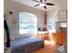 Well-lit bedroom with hardwood floors, a window and dresser, offering a cozy and inviting atmosphere at 6107 French Creek Ct, Ellenton, FL 34222