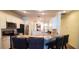 Modern kitchen with white cabinets, stainless steel appliances, and a breakfast bar for casual dining at 6107 French Creek Ct, Ellenton, FL 34222