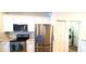 Contemporary kitchen with stainless steel appliances, white cabinetry, and seamless access to the laundry area at 6107 French Creek Ct, Ellenton, FL 34222