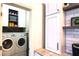 Convenient laundry area with modern washer/dryer units, custom shelving, and ample storage space at 6107 French Creek Ct, Ellenton, FL 34222