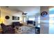 Cozy living room featuring tile floors, ceiling fan, and comfortable purple couches at 6107 French Creek Ct, Ellenton, FL 34222