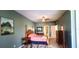 Spacious bedroom featuring a four-poster bed, complemented by a dresser and ample natural light at 6107 French Creek Ct, Ellenton, FL 34222