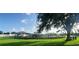 Community playground area with lush grass and mature shade trees at 6107 French Creek Ct, Ellenton, FL 34222