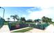 Fenced playground with various structures, lush greenery, and a safe play environment at 6107 French Creek Ct, Ellenton, FL 34222