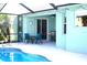 Outdoor pool area with screened-in patio and dining table with a grill at 6107 French Creek Ct, Ellenton, FL 34222