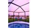Screened-in pool with table and chairs overlooks a beautiful lake at 6107 French Creek Ct, Ellenton, FL 34222