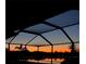 Covered pool overlooking a peaceful lake at dusk at 6107 French Creek Ct, Ellenton, FL 34222