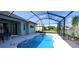 Screened-in pool with view of the backyard and canal at 6107 French Creek Ct, Ellenton, FL 34222