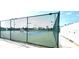 Well-maintained tennis court with a green fence and clear blue skies, perfect for sports enthusiasts at 6107 French Creek Ct, Ellenton, FL 34222