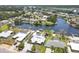 Waterfront homes featuring mature trees and docks along canal community at 619 Albee Farm N Rd, Nokomis, FL 34275
