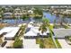 Waterfront home features a boat dock, lush landscaping and solar panels at 619 Albee Farm N Rd, Nokomis, FL 34275