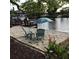 Inviting backyard beach area with chairs, umbrella, landscaping, and waterfront views at 619 Albee Farm N Rd, Nokomis, FL 34275