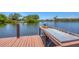 Lakeside dock features fish cleaning station with a serene backdrop for fishing or relaxation at 619 Albee Farm N Rd, Nokomis, FL 34275